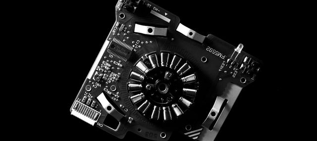 High contrast black and white close-up of a circuit board showcasing electronic components and intricate details. Photo by Miguel Á. Padriñán: https://www.pexels.com/photo/greyscale-photo-of-machine-part-and-mother-board-3520665/