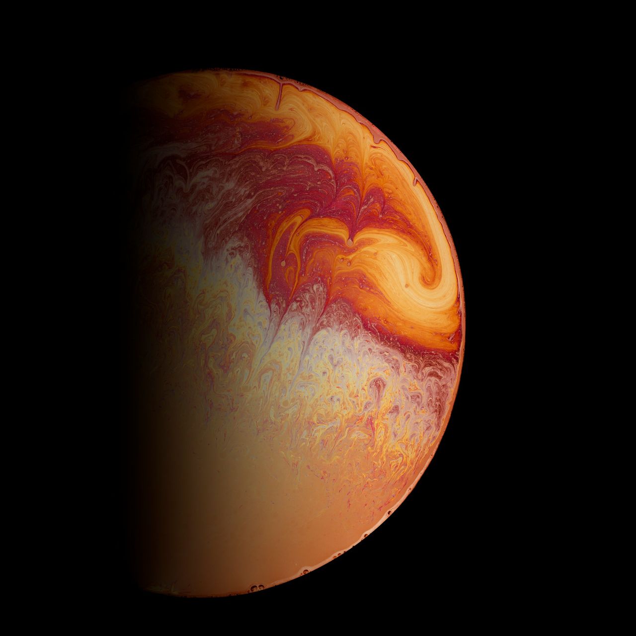 Orange and yellow colours diffusing in oil circle