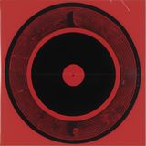 An abstract disc like a vinyl record on a red background